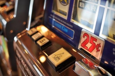 Overhead view of a jepe711 Three Card Poker table with multiple players' hands visible, mobile phones showing live betting interface in the foreground